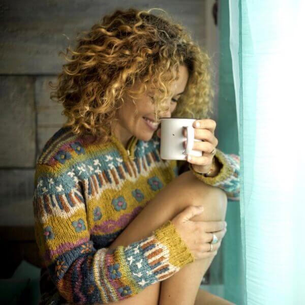 Woman enjoying organic coffee delivery at home.